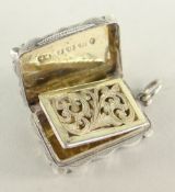 VICTORIAN SILVER VINAIGRETTE having engine turned exterior with vacant cartouche and belt buckle