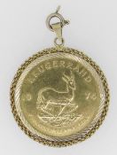 1974 1OZ GOLD KRUGERRAND IN 9CT GOLD MOUNT, 38 grams overall. Condition Report: In good overall