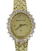 9CT YELLOW GOLD LADIES BUECHE-GIROD COCKTAIL WATCH, the oval dial surrounded by twenty-two