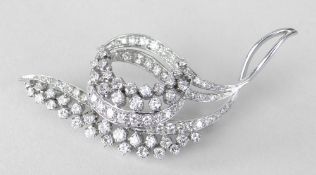 WHITE METAL DIAMOND ENCRUSTED LEAF AND SCROLL DESIGN BROOCH, 6.4cms at widest point, 12.9 grams.
