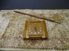 OAK ART DECO WALL CLOCK, vintage walking cane and a small modern rug