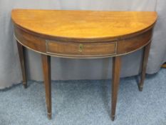 HALF MOON MAHOGANY FOLD-OVER TEA TABLE, circa 1860 with single central drawer on tapering supports