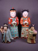 ORIENTAL POTTERY FIGURINES, two pairs including a boy and girl in colourful traditional costume,