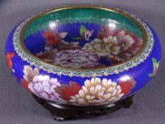20TH CENTURY CLOISONNE ENAMEL BOWL on hardwood stand, blue ground with large floral sprays and