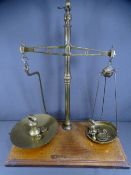 SHOPKEEPER'S OLD BALANCE SCALES with weights on a wooden base
