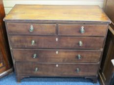 CROSSBANDED MAHOGANY CHEST of two short over three long drawers having Regency brass knobs and ivory