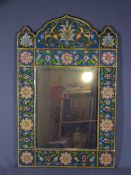 PERSIAN STYLE WALL MIRROR with reverse glass painting of floral sprays to the frame, 59 x 38cms