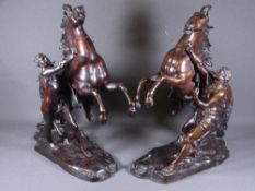 AFTER COUSTOU BRONZE MARLEY HORSES, a pair with attendants on rocky platform bases, 44cms H, 33cms