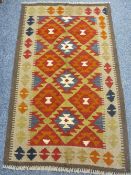MAIMANA KILIM SINGLE BORDERED RUG - with repeating central diamond pattern in reds and muted