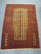 OLD BALUCHI - red ground and multi-bordered with a central repeating block, 135 x 98cms