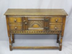 PRIOR STYLE OAK NEATLY PROPORTIONED SIDEBOARD, carved detail to a central cupboard door and flanking