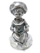 VINTAGE CAR ACCESSORY MASCOT- YOUNG SEATED BOY wearing a hat and holding a ball, 9cms H.