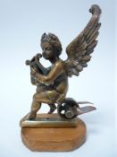 VINTAGE CAR MASCOT- WINGED CHERUB WITH LYRE seated on a wheel, possibly mounted as a mascot, LOZENGE