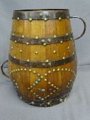 A BANDED AND STUDDED HANDLED WOODEN tub of shaped form