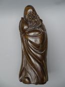 AN ORIENTAL HARDWOOD FIGURE of an old sage 37 cms high