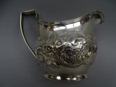 SILVER CREAM JUG, oval with scrolled and floral decoration, 4 ounces London 1807.