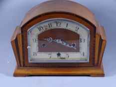 MANTLE CLOCK- a dome topped mahogany and chrome striking clock (damaged areas to dial)