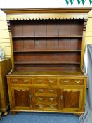 WELSH DRESSER-MAHOGANY, OAK AND PINE with a 3-shelf rack over 3 centre opening drawers, a false base