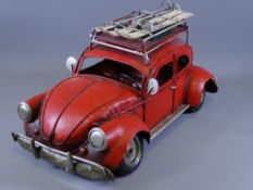 A VW BEETLE MODEL CAR WITH rack and skis