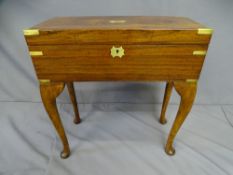 A GENTLEMAN'S LAP DESK- rosewood and brass banded with inset end brass handles. On a purpose made