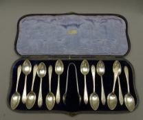 SILVER COFFEE SPOONS, a cased set of 12 with tongs, 4.9 ounces Sheffield 1923
