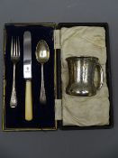 SILVER MUG, slightly waisted with scrolled decoration, 1.6 ounces, marks indistinct and a cased