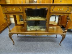 AN EDWARDIAN MAHOGANY BASE OF A SIDEBOARD CABINET, centre shaped glass door with end open shelves,