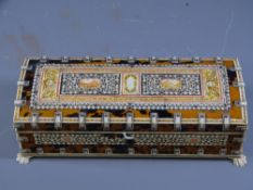 AN INDIAN BONE AND TORTOISHELL oblong lidded box with angelic and animal inlays, on corner claw