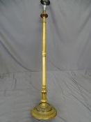 A WALNUT STANDARD LAMP on a circular carved base.