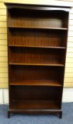 A MODERN DARK WOOD COMPACT STANDING BOOKCASE with loose shelves 84 cms wide