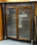 19TH CENTURY ROSEWOOD BOOKCASE having two glazed doors, column supports with carved acanthus