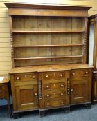 19TH CENTURY ANGLESEY WELSH DRESSER, the base with flanking cupboards and six drawers, on bracket