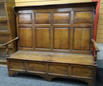 18TH CENTURY JOINED OAK BOX SETTLE, angled top with brackets above eight paneled tall back,