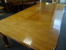 GEORGE IV MAHOGANY EXTENDING DINING TABLE on fluted, reeded corner and centre supports with brass