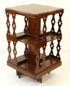 ANTIQUE MAHOGANY REVOLVING BOOKCASE TABLE with shaped top and gothic-style pierced sides, 47 x 47cms