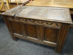 18TH CENTURY OAK COFFER with lunette carved frieze and moulded uprights, 119cms wide