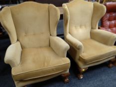 PAIR OF REPRODUCTION GEORGIAN-STYLE WING-BACK ARMCHAIRS on carved ball and claw supports, caramel