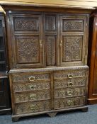 ANTIQUE OAK LINEN PRESS, paneled doors and front later carved with floral decoration on base woth
