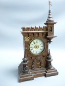GERMAN MANTEL CLOCK, castellated form with turrets, the enamelled dial set with Roman numerals