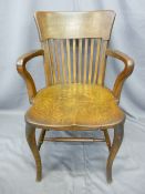 VINTAGE OAK OFFICE ARM CHAIR having curved and slatted back with shaped arms and solid seat on