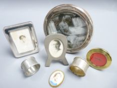 SILVER CIRCULAR PHOTO FRAME, three others, two napkin rings and a Limoges porcelain brooch