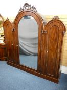 VICTORIAN MAHOGANY TRIPLE WARDROBE three-section arched tops with carved mounts above a large