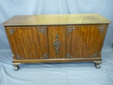 REPRODUCTION MAHOGANY LOW SIDEBOARD with applied carving, on ball and claw feet (ex-entertainment