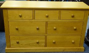 ULTRAMODERN OAK CHEST OF SEVEN DRAWERS WITH TURNED WOODEN KNOBS, 78cms high x 134cms wide x 45cms