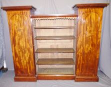 EARLY VICTORIAN MAHOGANY BOOKCASE with central open section and flanking pedestal-type cabinets with
