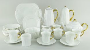 EXTENSIVE SHELLEY TEA & COFFEE SERVICE IN THE 'DAINTY' PATTERN in plain white glaze with gold