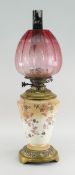 LATE VICTORIAN BRASS MOUNTED OIL LAMP with etched cranberry shade