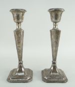 PAIR GEORGE V SILVER CANDLESTICKS, Chester 1912, tapering square form, loaded bases, 22.5cms high (