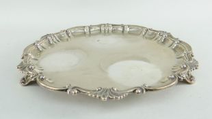 VICTORIAN SILVER SALVER with applied shell and scroll border, raised over three scroll shell feet,