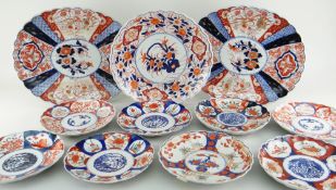 ELEVEN JAPANESE IMARI CHARGERS including two good oval fanned, 37cms wide (11)